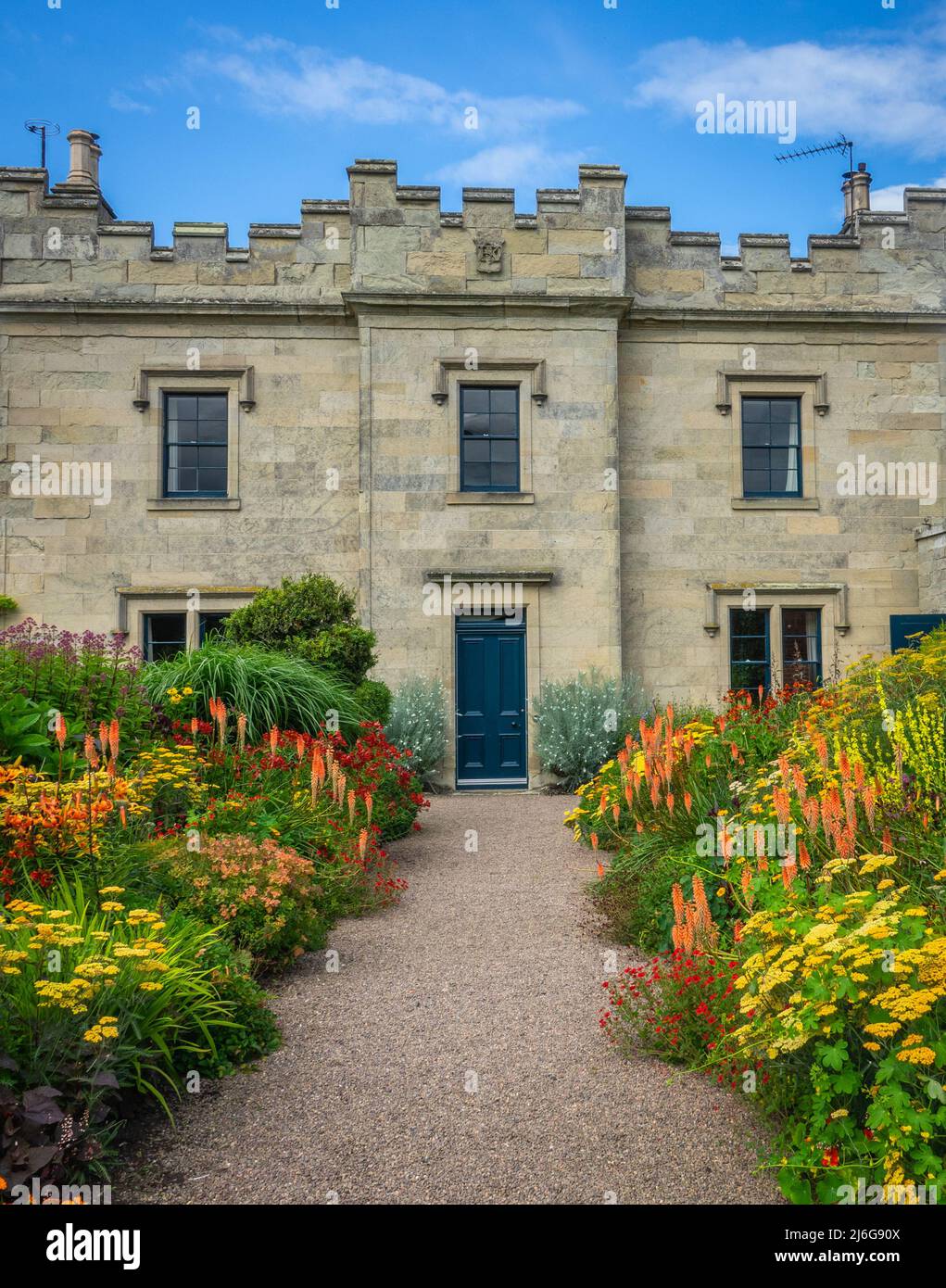 Beautiful Flowerbeds Lining The Approach To A Grand Old English Stately Home Or Mansion Stock Photo