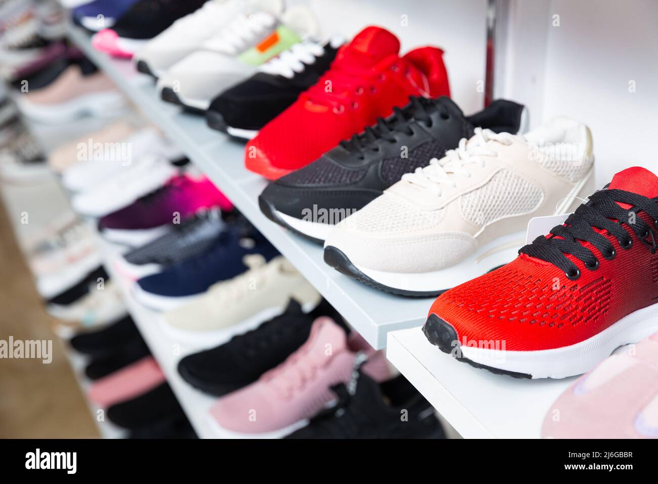 Shelves with sport shoes in shoes shop Stock Photo - Alamy