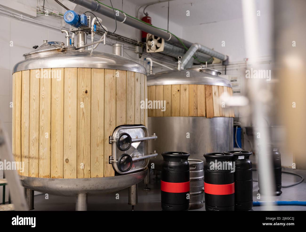 Beer tanks and barrels in brewery Stock Photo Alamy