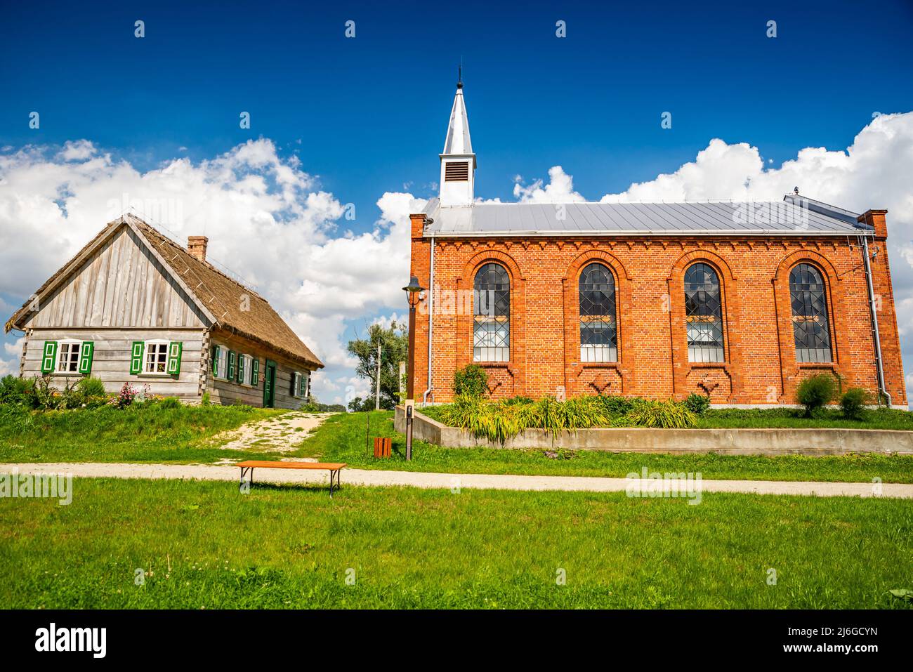 Wiaczemin Polski, Poland - August 12, 2021. Open-air museum of the Vistula settlement - Skansen Osadnictwa Nadwislanskiego - church and school Stock Photo