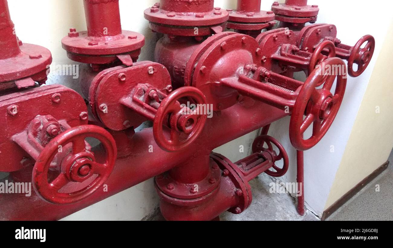 Fire hydrants. The red water pipes with spigot. Stock Photo