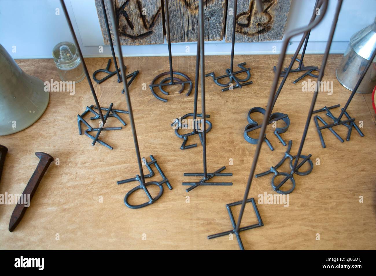 Branding irons for cattle standing up on display Stock Photo - Alamy