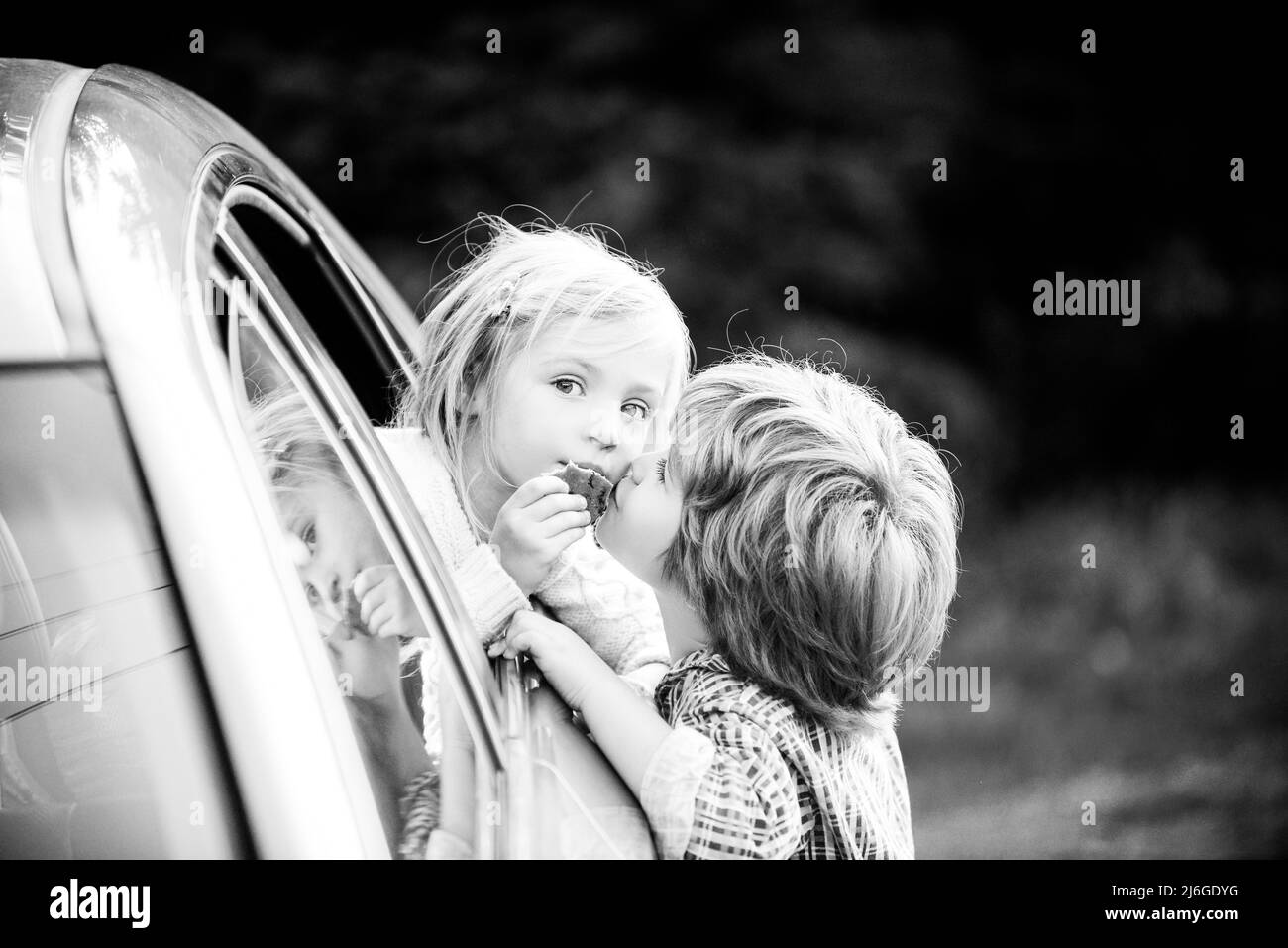 Funny little couple saying goodbye before car travel. Farewell child