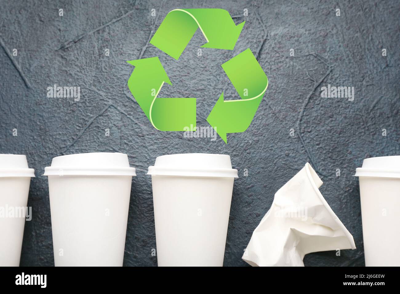 Takeaway paper cups and symbol of recycling on dark background Stock ...