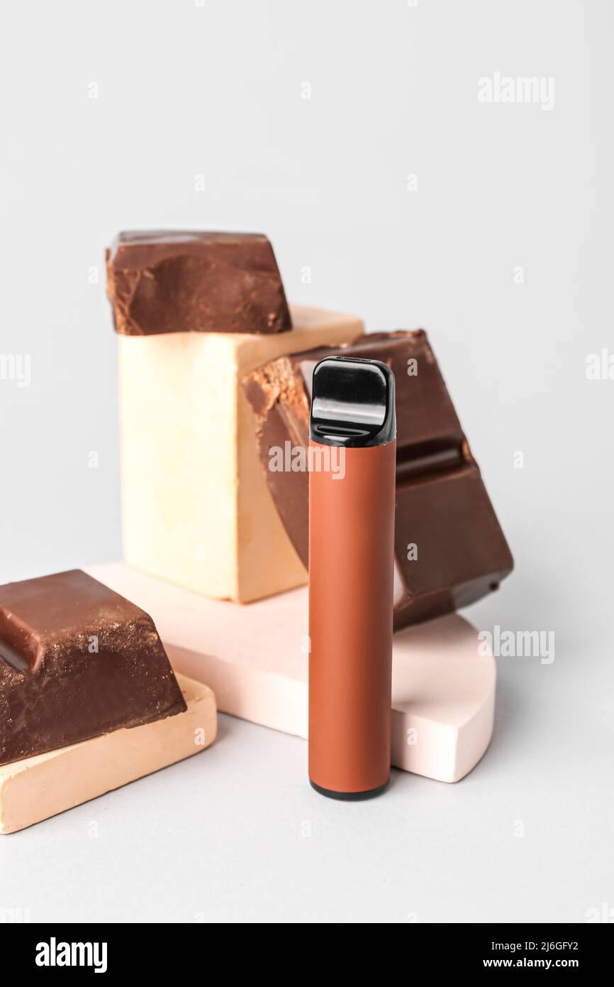 Disposable electronic cigarette and chocolate on light background Stock Photo - Alamy Disposable electronic cigarette and chocolate on light background Stock Photo - Alamy