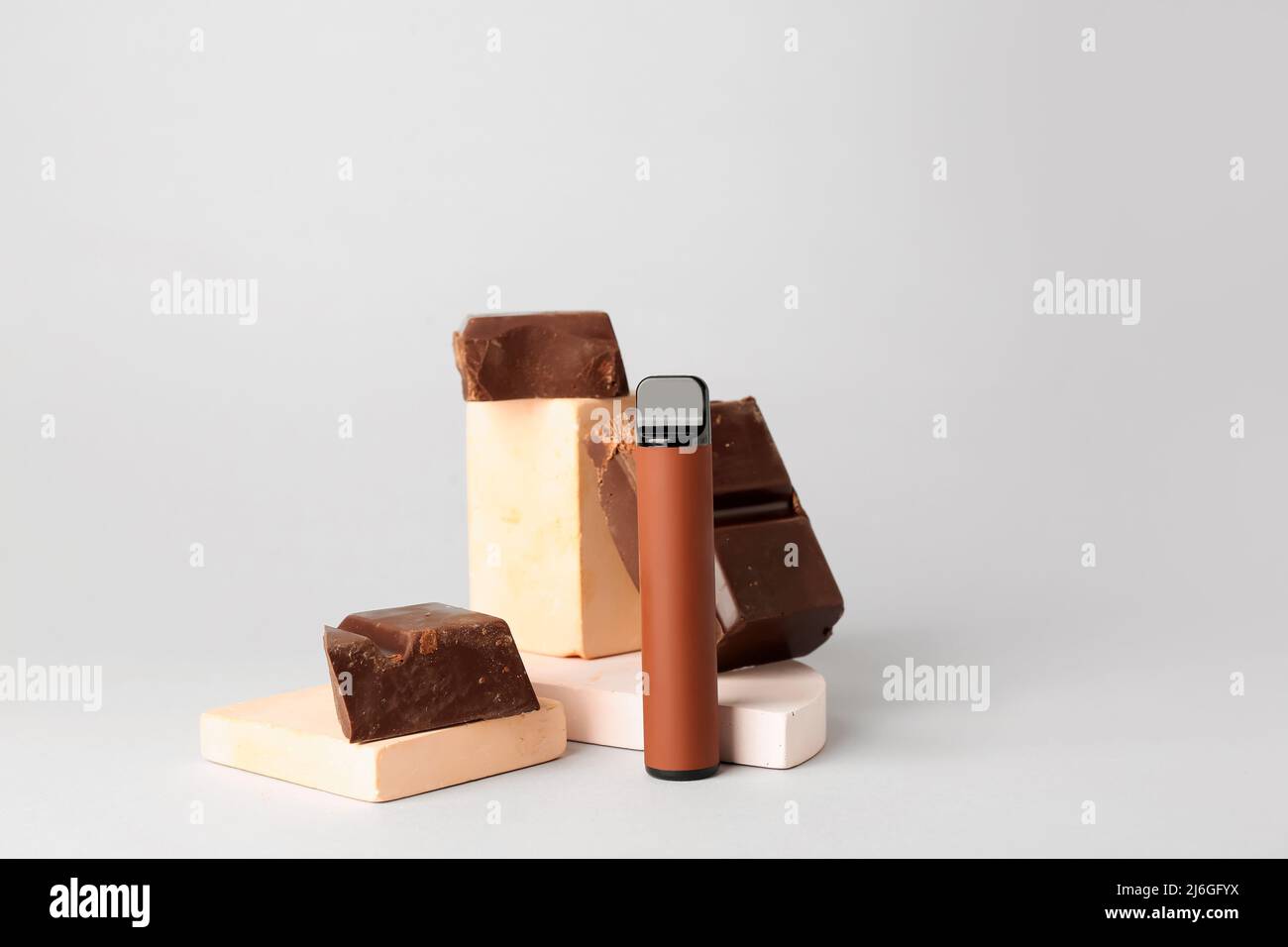 cigarettes and chocolate Disposable electronic cigarette and chocolate on light background Stock  Photo