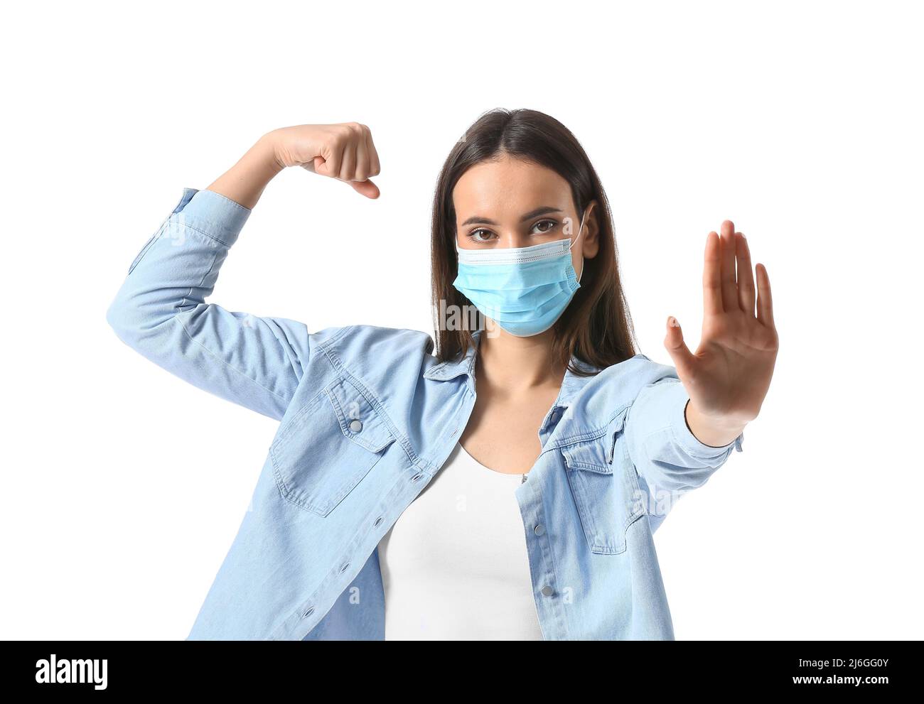 Young woman in medical mask showing stop gesture on white background ...