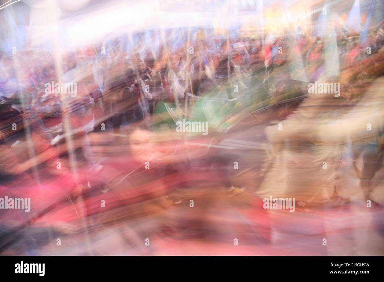 Long exposure photograph of a crowd, people marching during a demonstration. Intentional motion blur. Concepts: social protest, motion, dynamism, chao Stock Photo