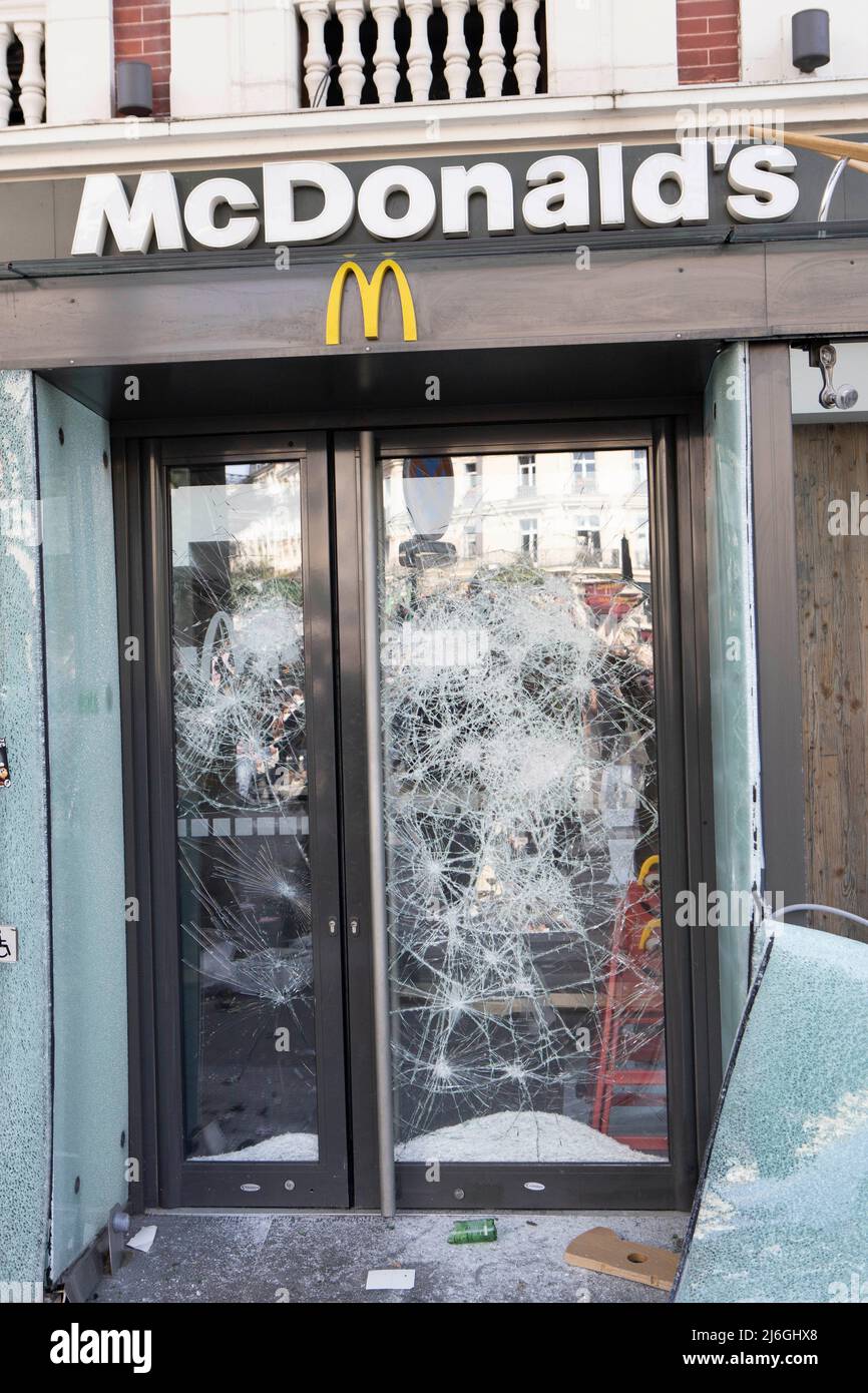 The door to McDonald's restaurant on the Place Leon Blum seen ransacked by 'Black Bloc' anarchists during the demonstration. Thousands of demonstrators joined the May Day March in Paris on 1st May, International workers day. The March started from La Republique Square towards Nation Square. Stock Photo