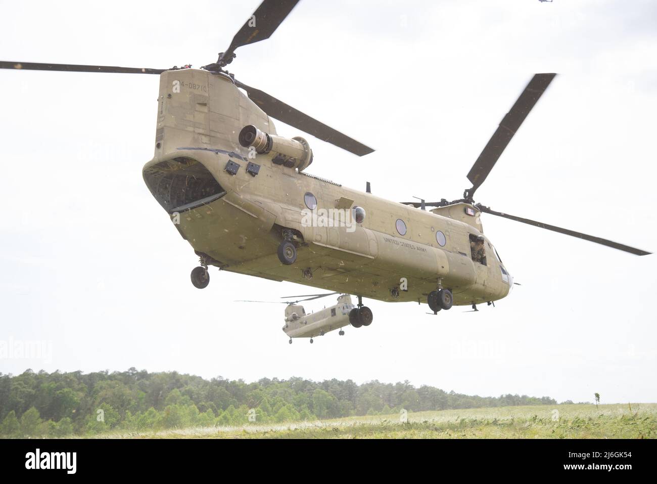 Two CH-47 Chinook helicopters with 185th Aviation Brigade, Mississippi Army National Guard, land to pick up U.S. Army Soldiers during a Proof of Concept exercise at Camp Shelby Joint Forces Training Center, Mississippi, April 29, 2022. The exercise was a part of Southern Strike 2022, a special operations-centric exercise that promotes interoperability between special forces, conventional ground forces, and air assets in order to ensure the U.S. military stays relevant and ready to respond to a peer-to-peer, large-scale combat operation. (U.S. Air National Guard photo by Tech. Sgt. Charles Wesl Stock Photo