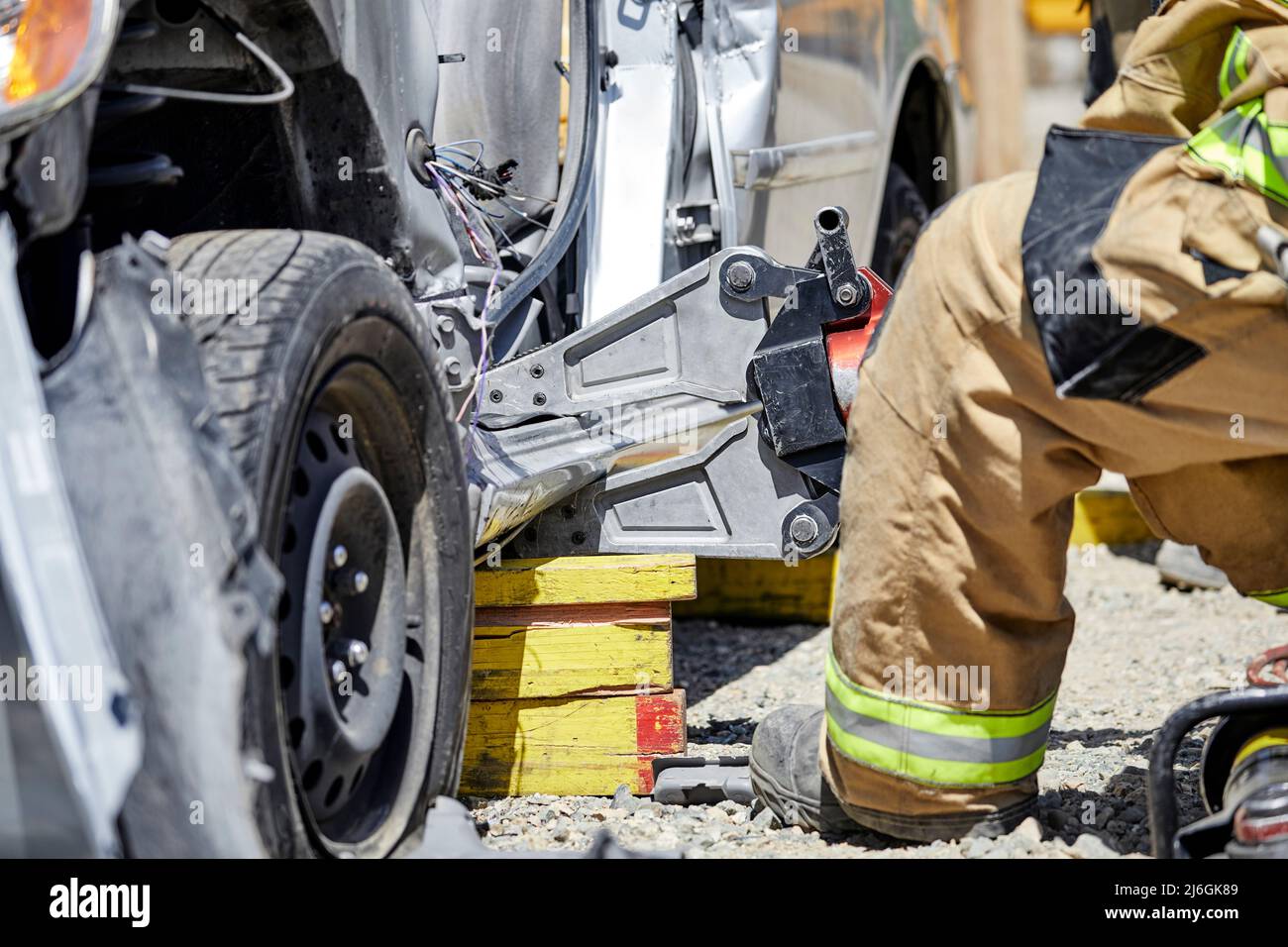 Fire Fighters using the Jaws of Life to dismantle a car during a demonstration Stock Photo