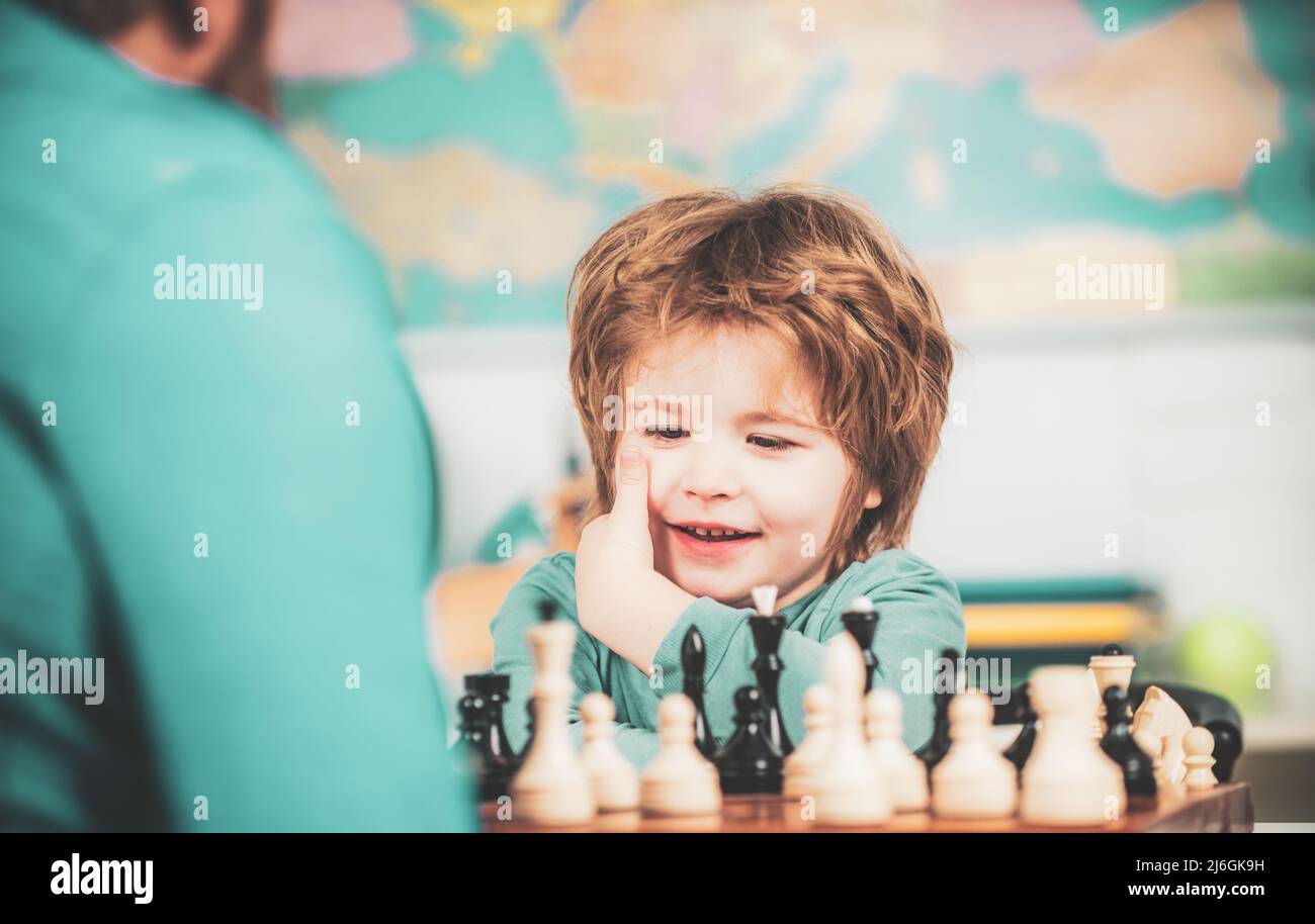 At home. Educational games. Preschooler or schoolboy, Cheerful smiling little boy sitting at the