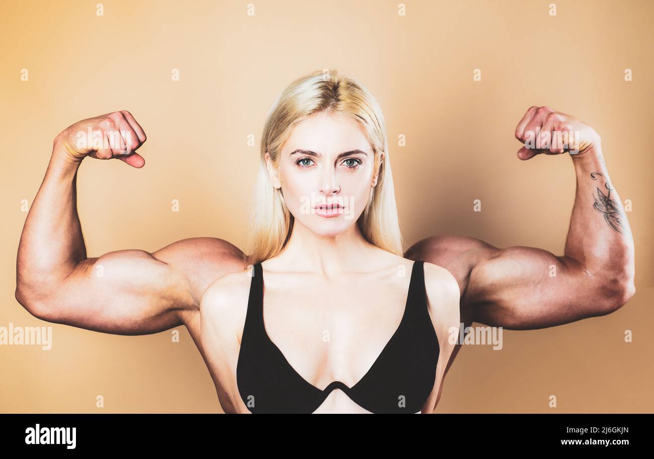 Female model keeps fit and healthy, raises hands and shows muscles, power. Strong muscle arms. Funny sport, woman with man muscle arms on back. Young Stock Photo