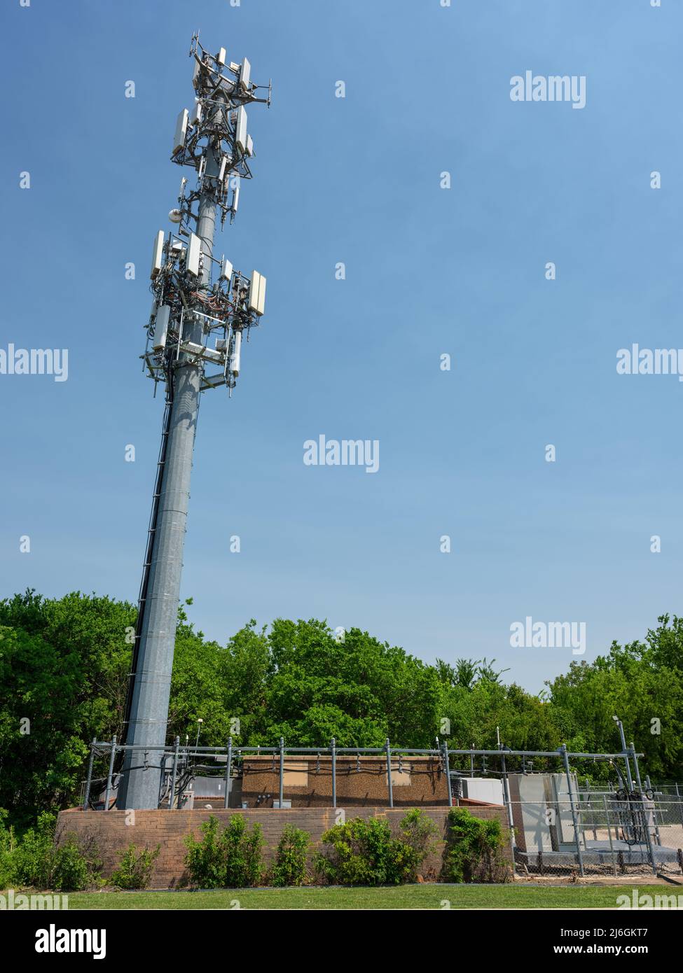 A cell tower and base transceiver station supplies 4G and 5G mobile broadband connections in suburban Fort Worth, Texas. Stock Photo