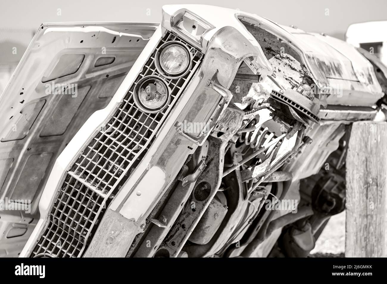 Vintage junked car propped on its side exposing the bottom of the car Stock Photo