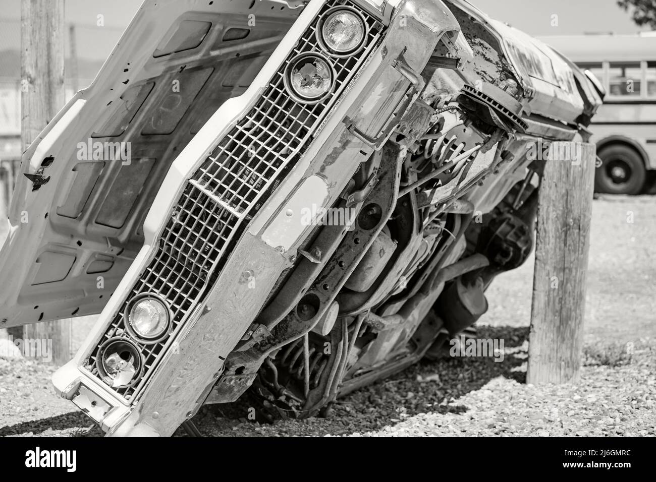 Vintage junked car propped on its side exposing the bottom of the car Stock Photo