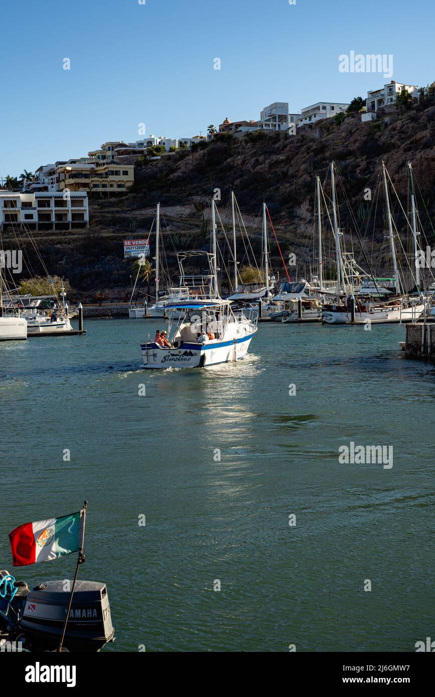 A small sport fishing boat heads out of the marina in San Carlos, Sonora, Mexico. Stock Photo