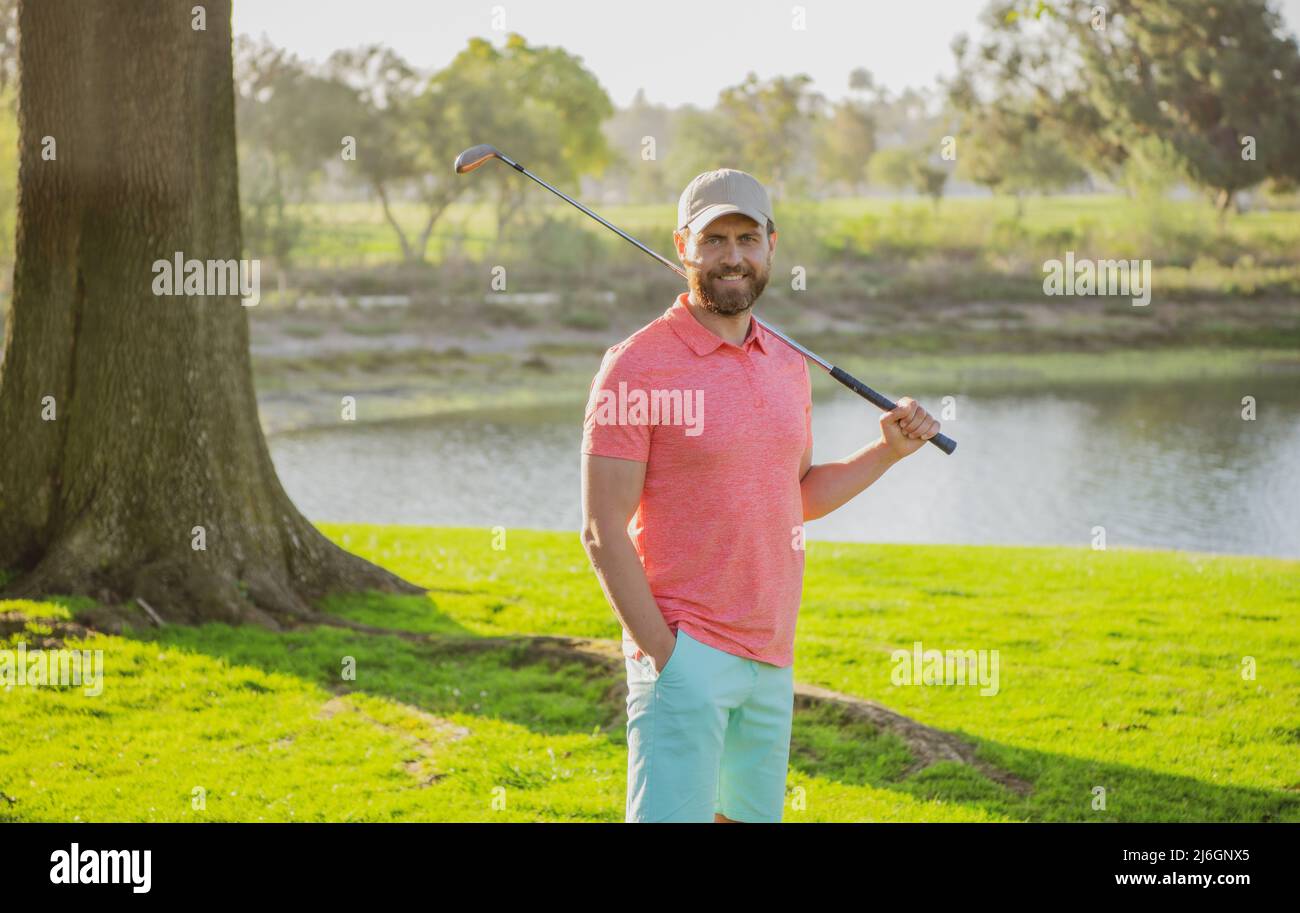 Golfer hitting golf shot with club on course Stock Photo Alamy