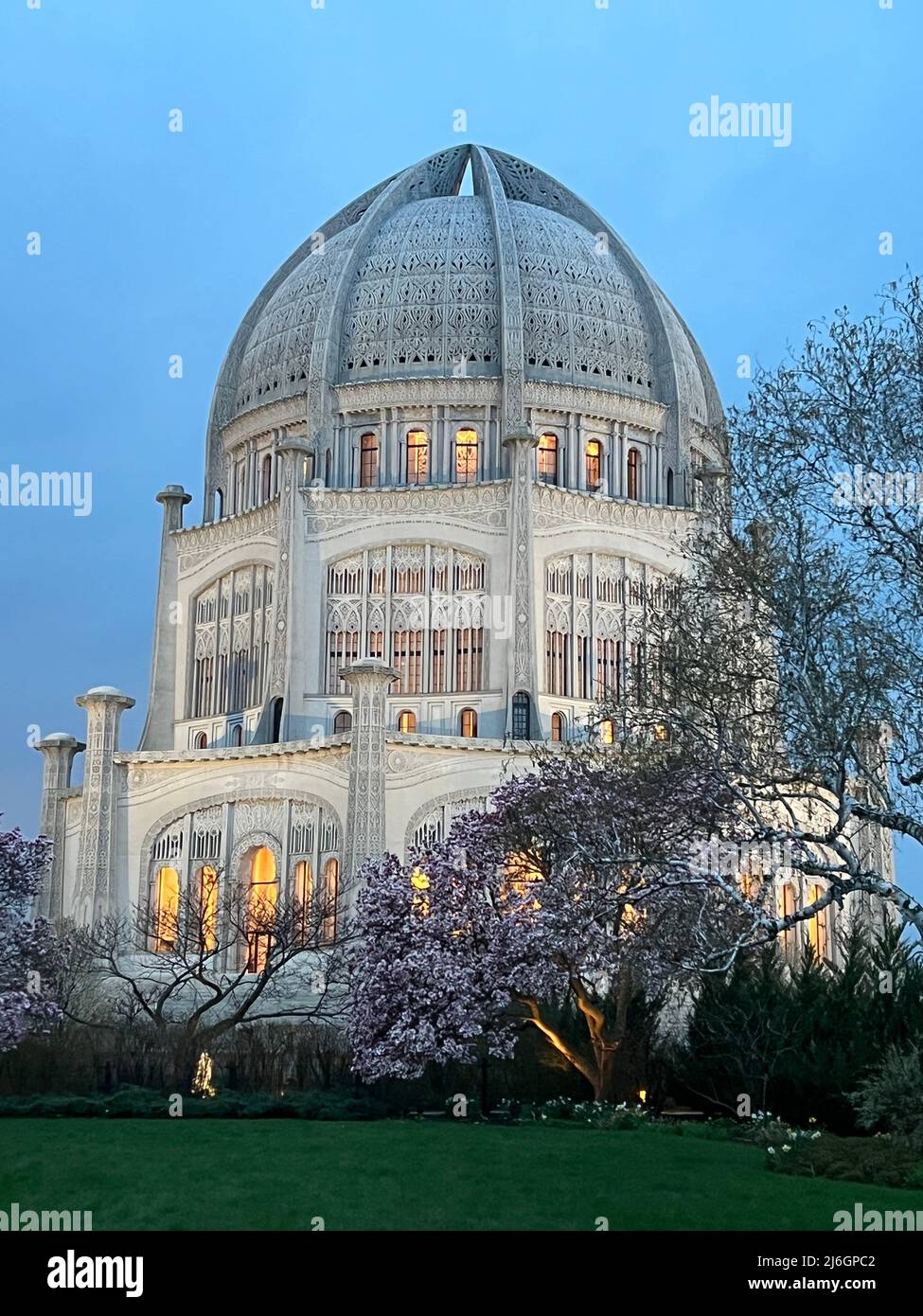 Baha'i House of Worship on an early spring evening with flowering trees in bloom. The temple is located in Wilmette, Illinois. Stock Photo