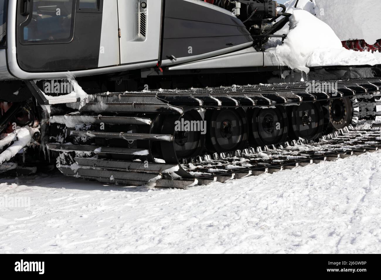 Snow grooming machine preparing ski slope at  ski resort Stock Photo