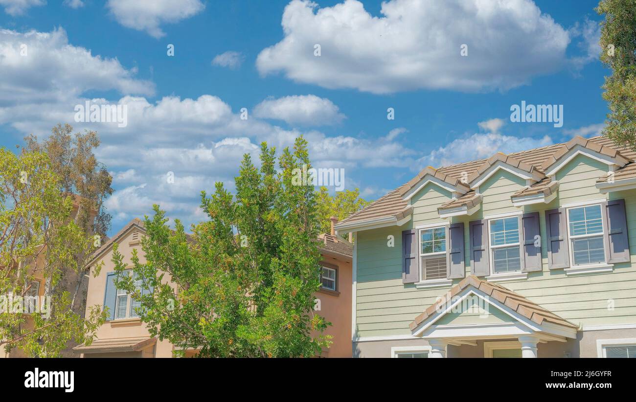 Panorama White puffy clouds Row of traditional houses at Ladera Ranch in Southern California Stock Photo