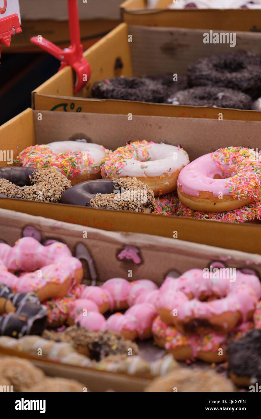 A market bakery stall full of glazed donuts Stock Photo