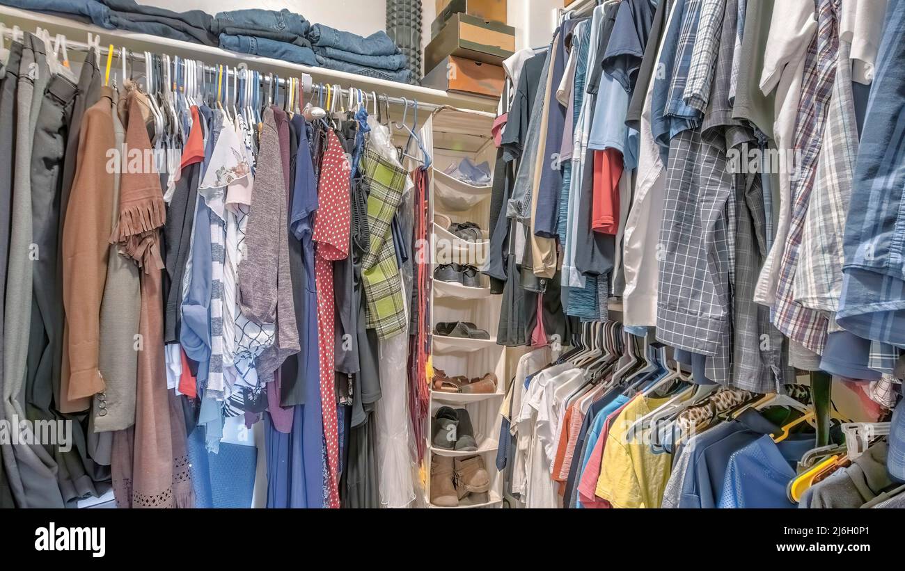 Panorama Walk-in closet with hanging linen shoe rack and clothes Stock Photo