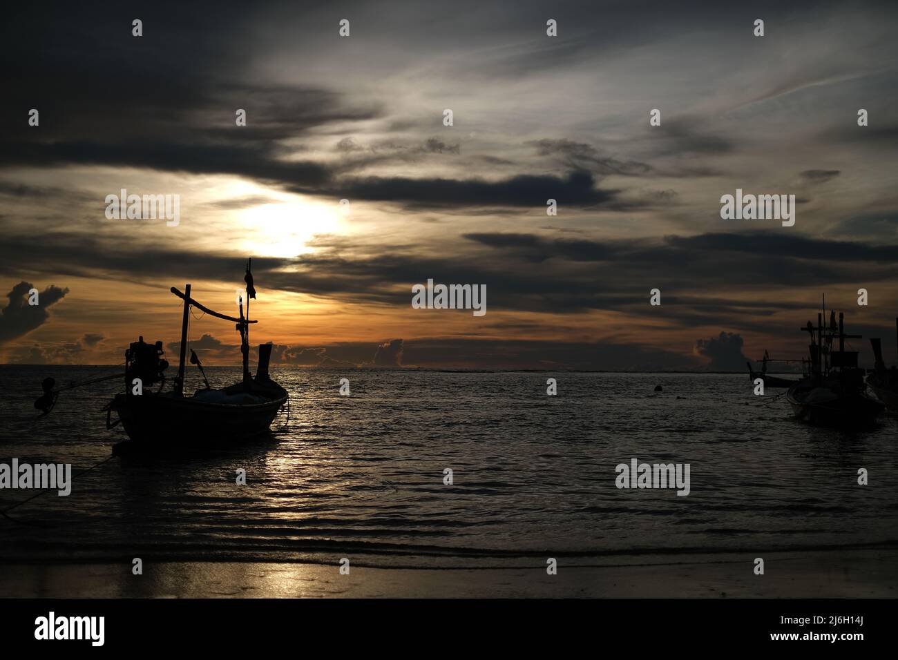 A fishing boats, lit by setting sun, ready for a night departure to Andaman sea Stock Photo