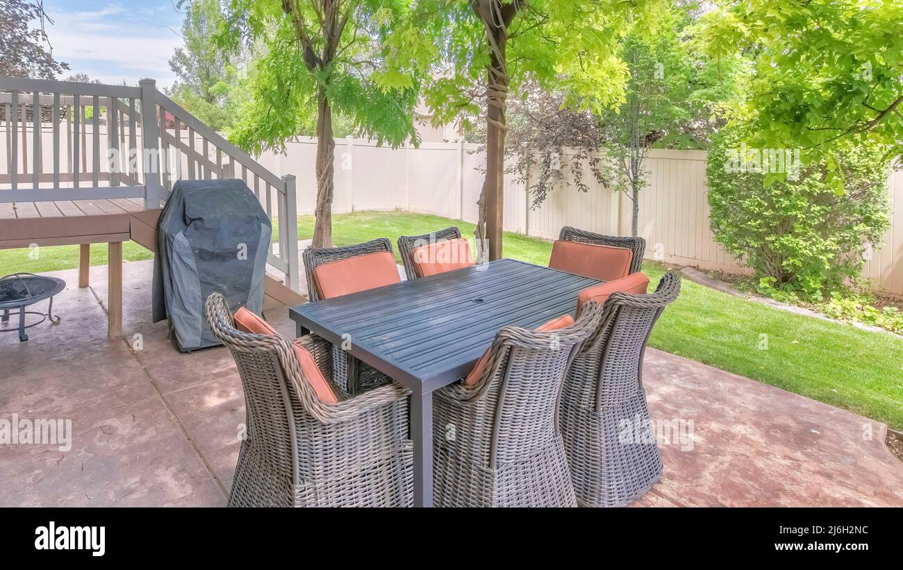 Panorama Outdoor patio with covered barbecue grill under a pergola roof