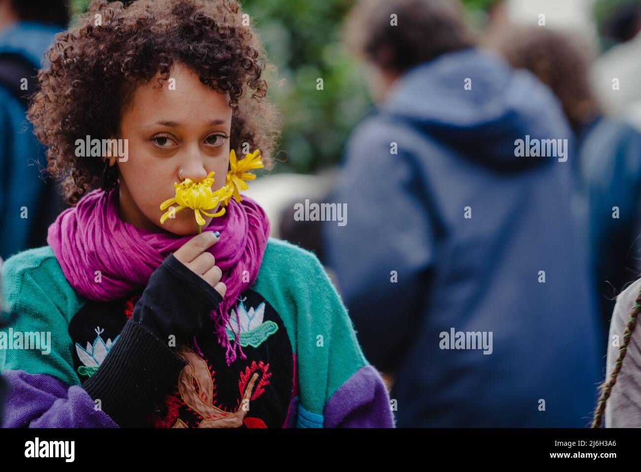 Sao Paulo, Brazil. 28th May, 2011. Woman with a flower in her mouth as demonstrators gather outside Art Museum of Sao Paulo (MASP) during 'Marcha da Liberdade' (Freedom March) along Paulista Avenue in Sao Paulo, Brazil. Despite the prohibition, the demonstrators were concentrated at MASP. After an initial delay the march set-off following talks between police and and leaders of the march, the protest was released to start at 16:00, since there is no apology to drugs. The Freedom March emerged after the police repression that occurred a week earlier, at the 'Marcha da Maconha' (Marijuana March) Stock Photo