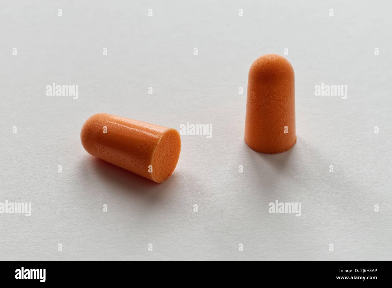 Orange foam ear plugs isolated on white background Stock Photo Alamy