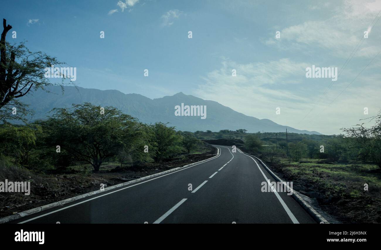 Long straight road leading to the hills of Fogo island on Cabo Verde ...