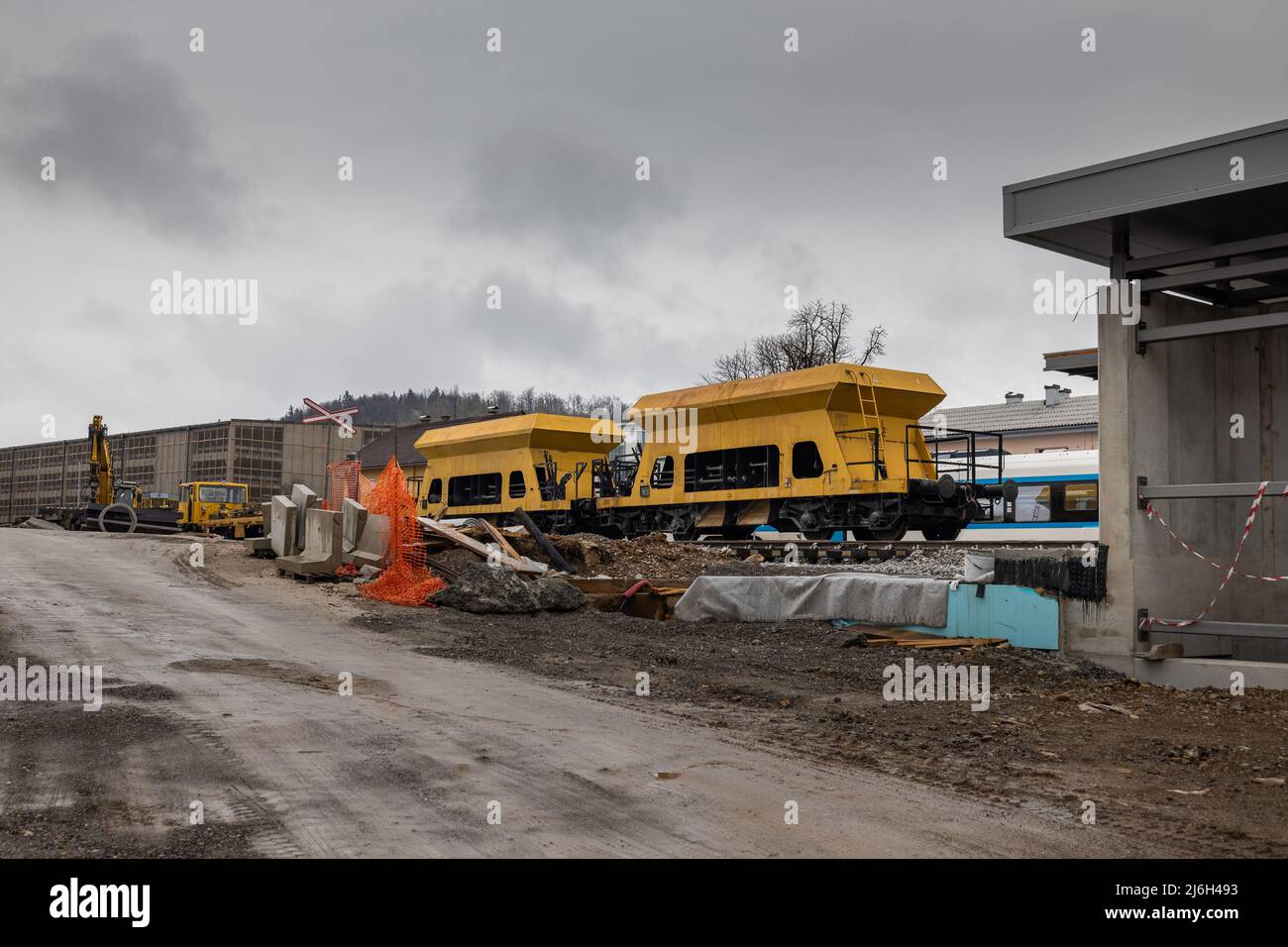 Construction site of a train station of Grosuplje, that is being renovated. Cold  spring day with clouds, visible yellow gravel waggons Stock Photo - Alamy