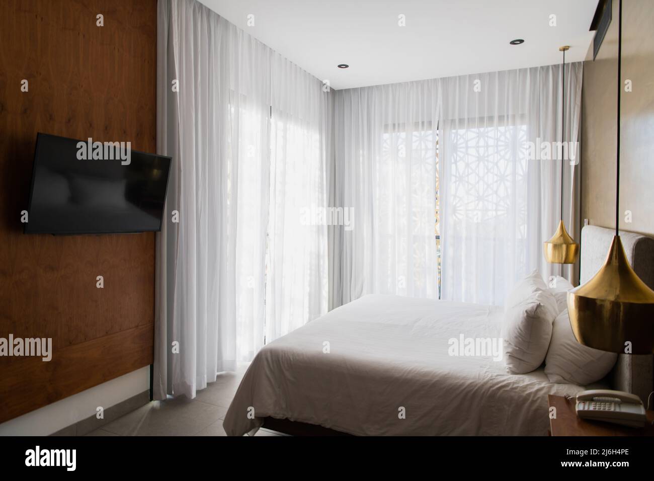 Queen size bed with bed runner and reading lamp in villa, house and apartment Stock Photo Alamy