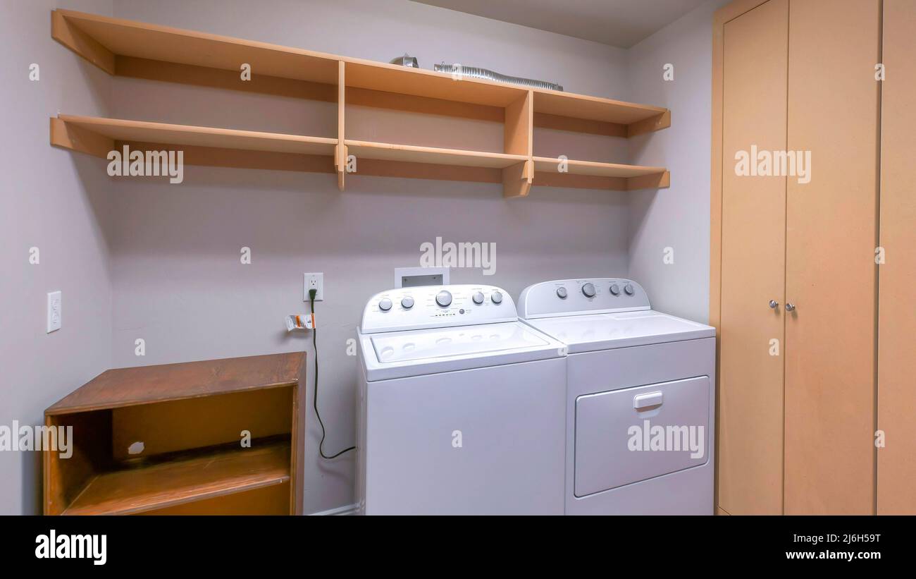Panorama Laundry room interior with closet, wooden racks and shelves ...