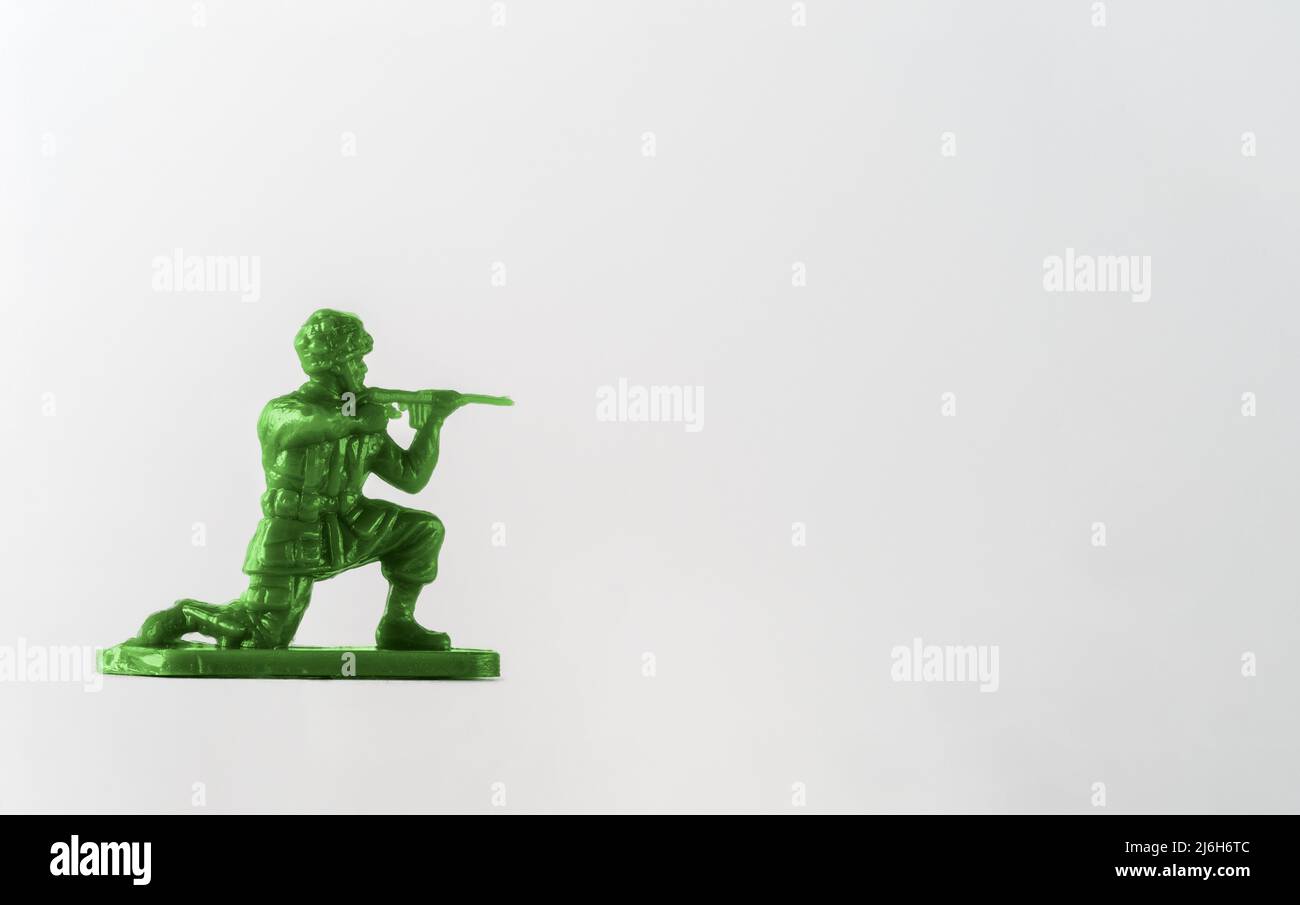 Green Plastic toy soldier American Paratrooper in a prone position with rifle Stock Photo