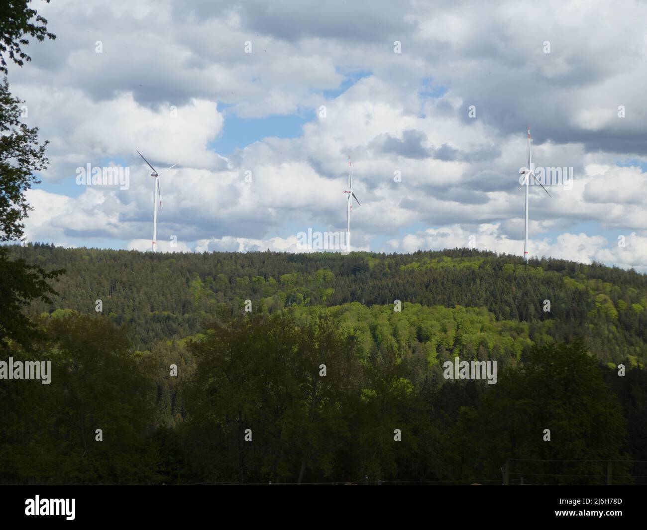 Three wind turbines on a hill near Eiterbach Stock Photo