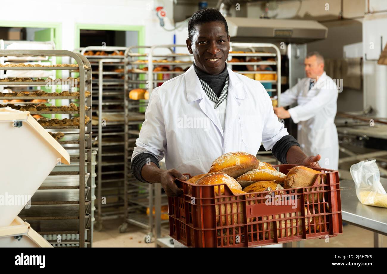Portrait of successful baker during daily work in bakeshop Stock Photo ...