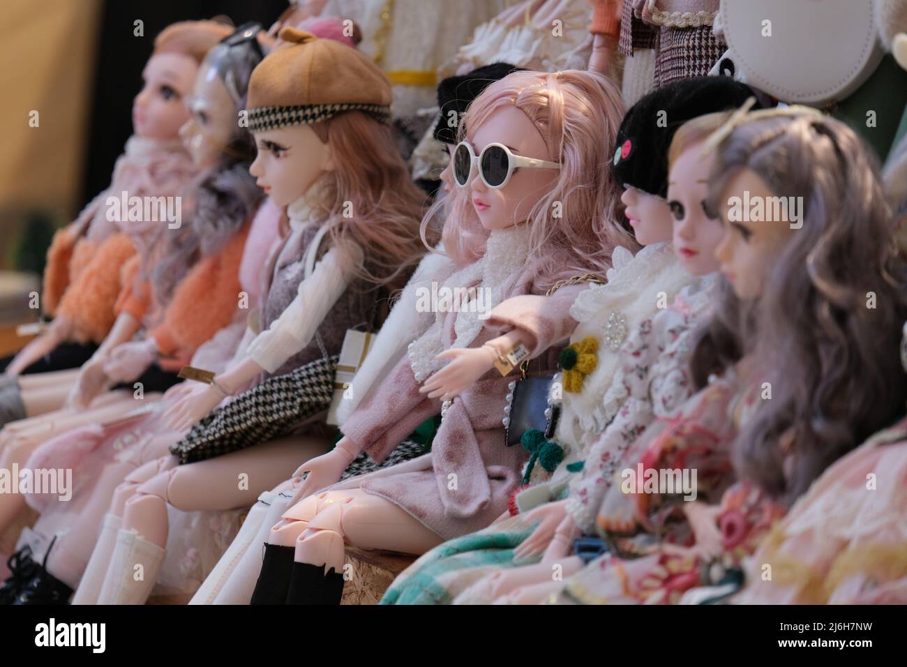 A row of lavishly dressed dolls Stock Photo