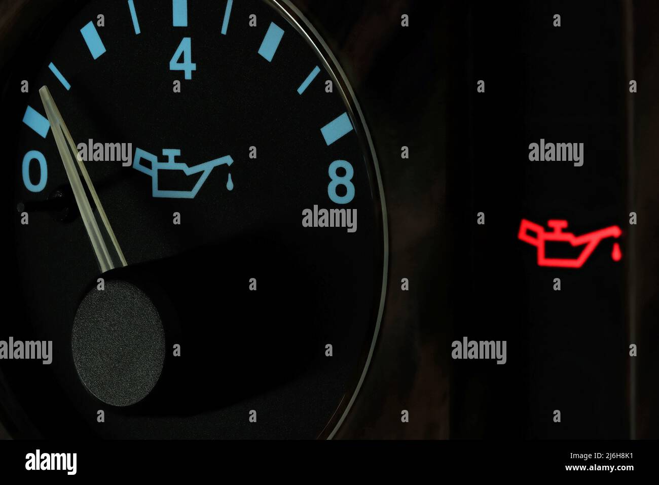 oil pressure gauge in car dashboard in illuminated night mode low