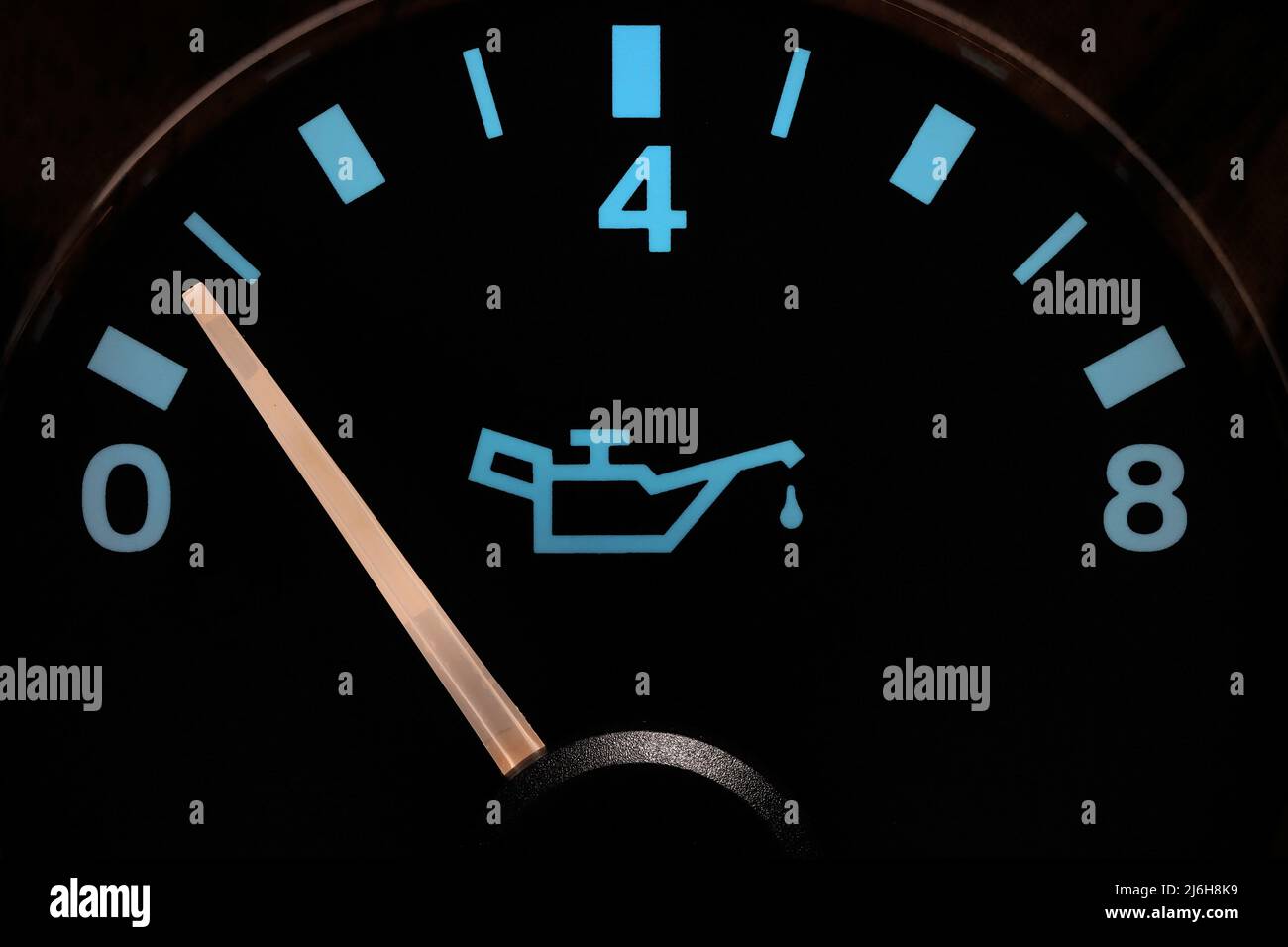 oil pressure gauge in car dashboard in illuminated night mode low