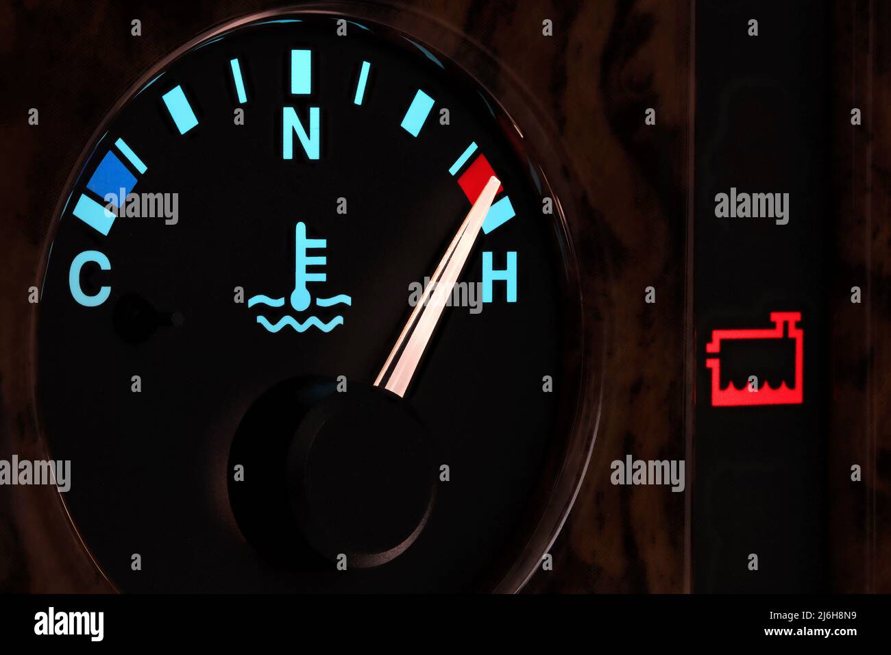 temperature gauge in car dashboard in illuminated night mode hot