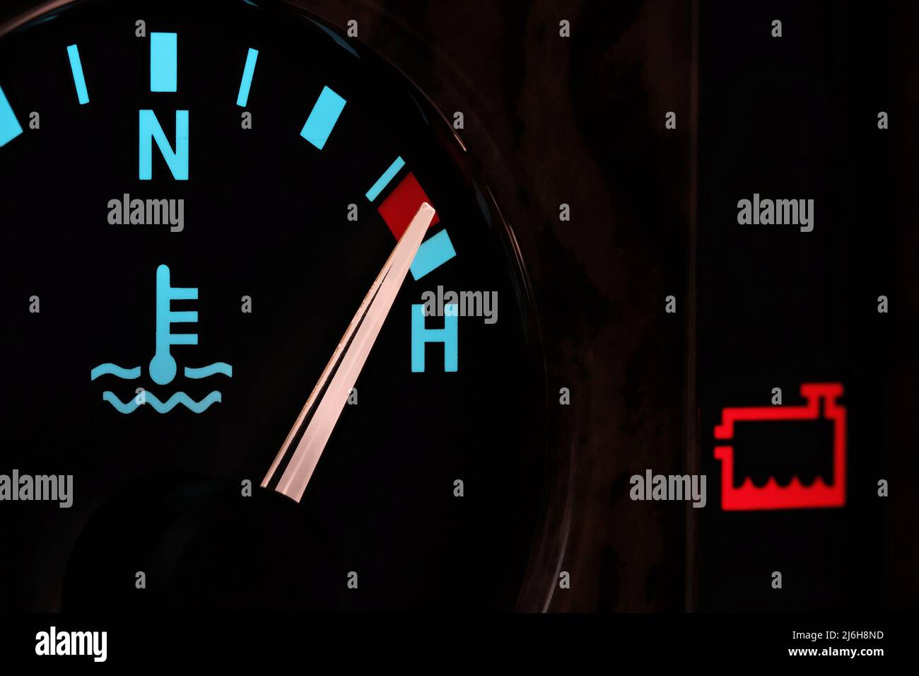 temperature gauge in car dashboard in illuminated night mode hot
