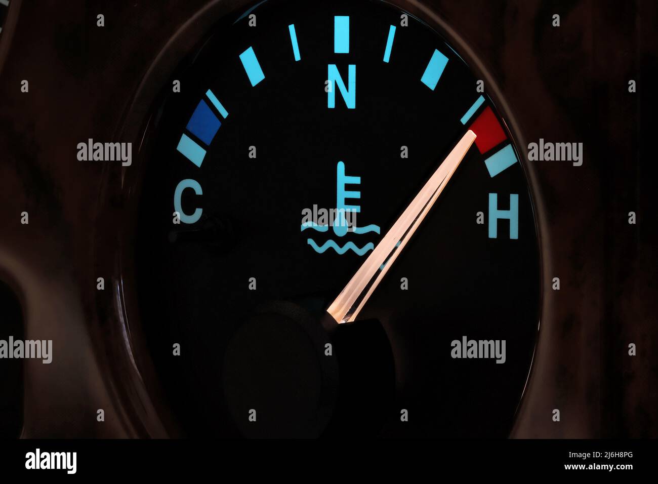 temperature gauge in car dashboard in illuminated night mode hot