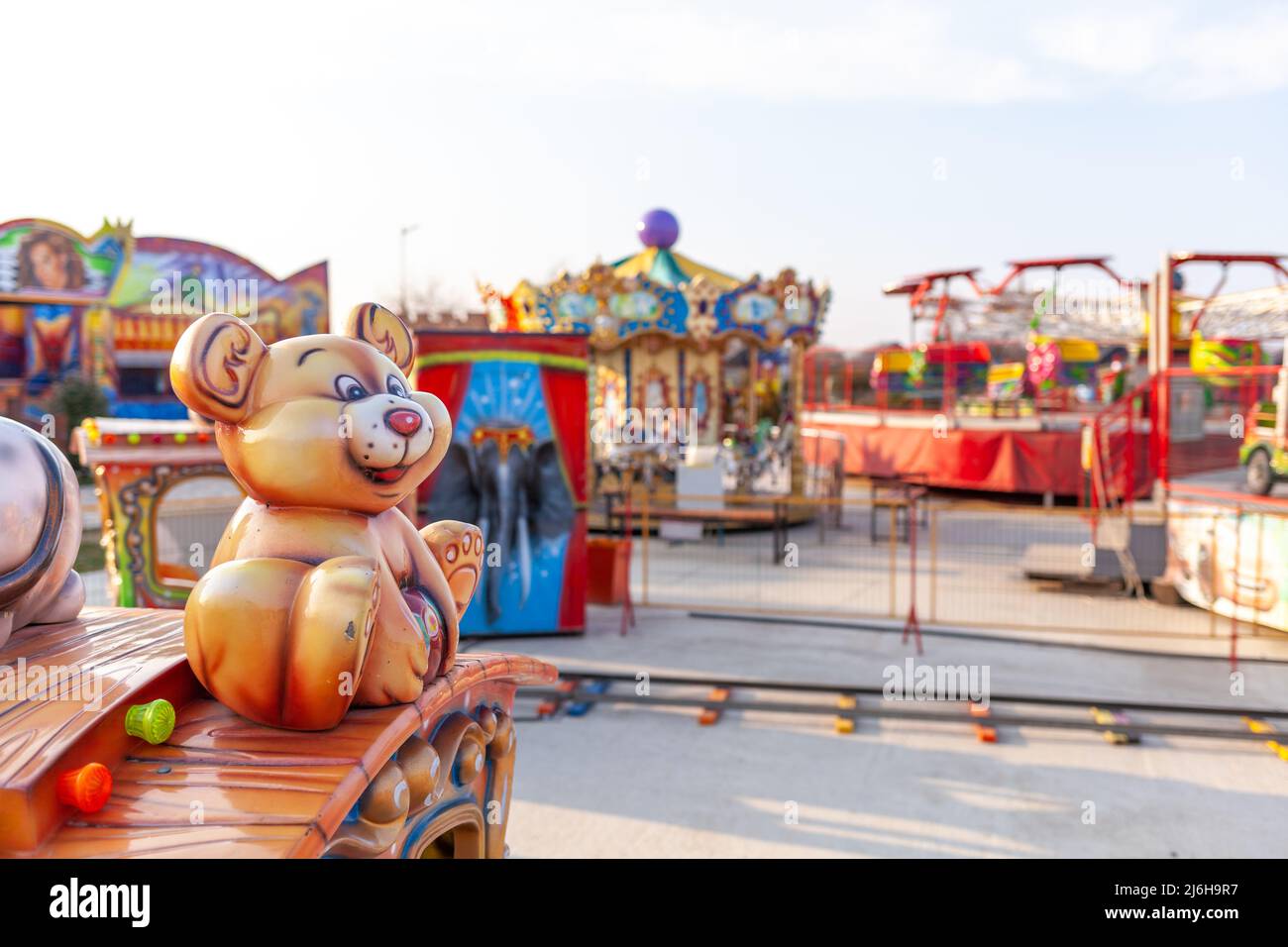 Children's rides and carousels are closed and empty. Joy and entertainment for children. Bright carousels and carriages for transporting children are Stock Photo