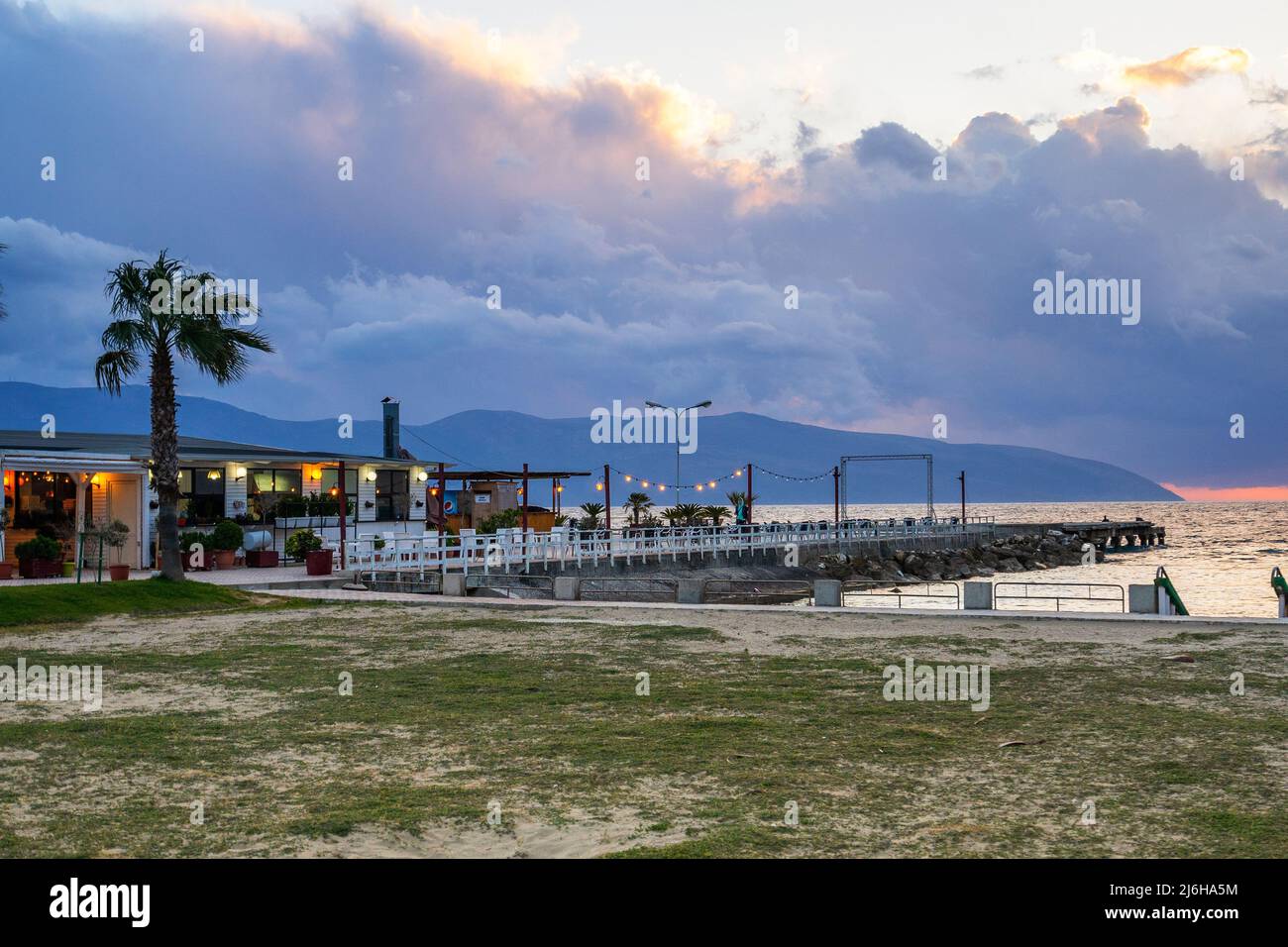 cafe by the sea. restaurant on the beach at sunset Stock Photo