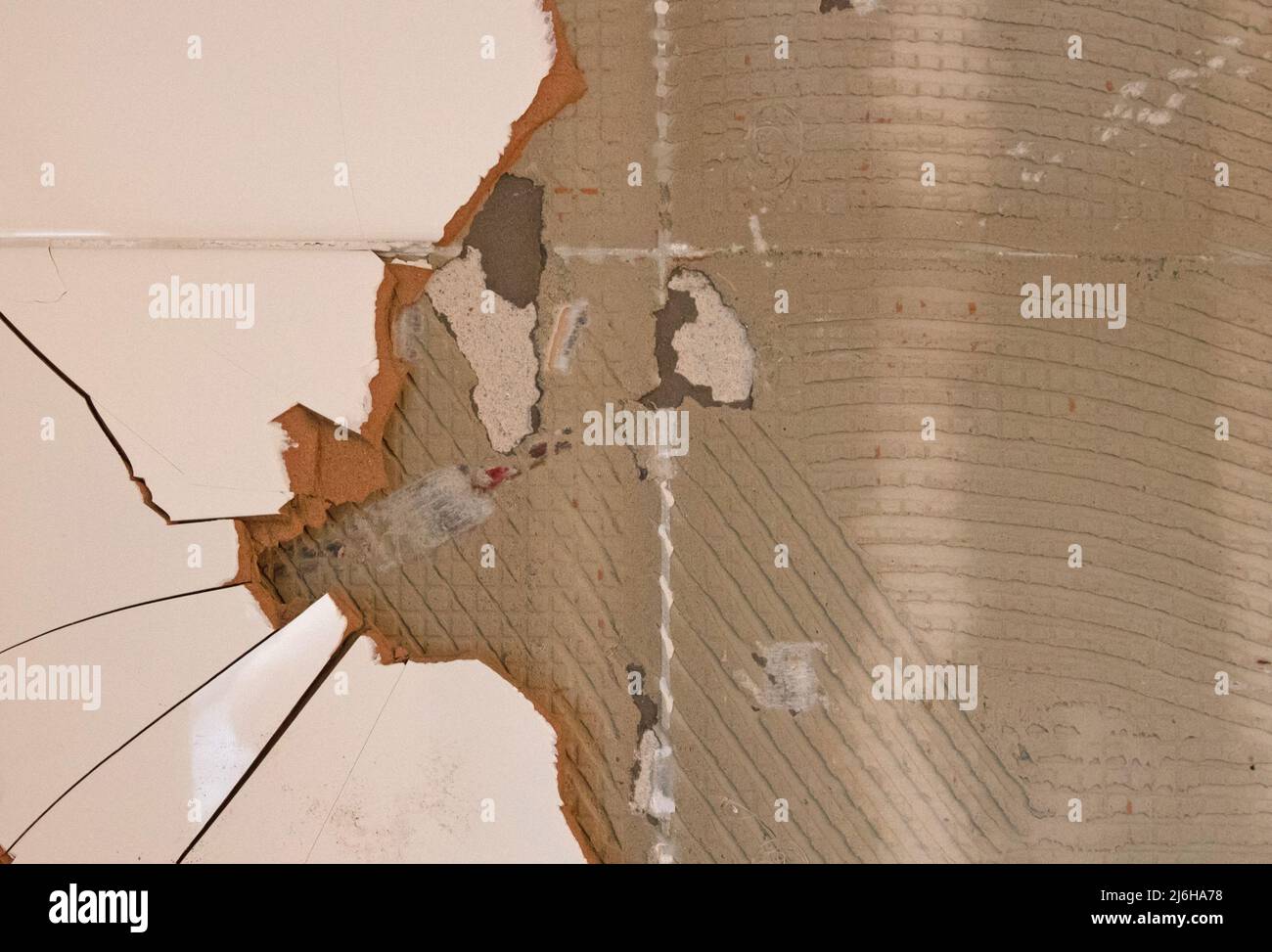 Breaking ceramic tiles, work in progress, maintenance Stock Photo Alamy