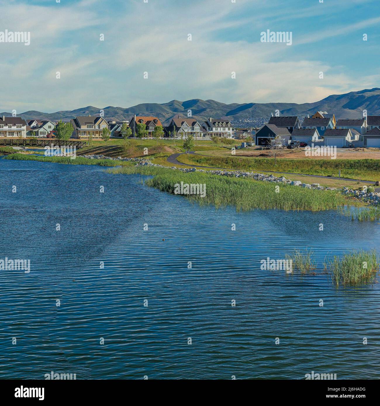 Square Whispy white clouds Oquirrh Lake at Daybreak in Utah with paved
