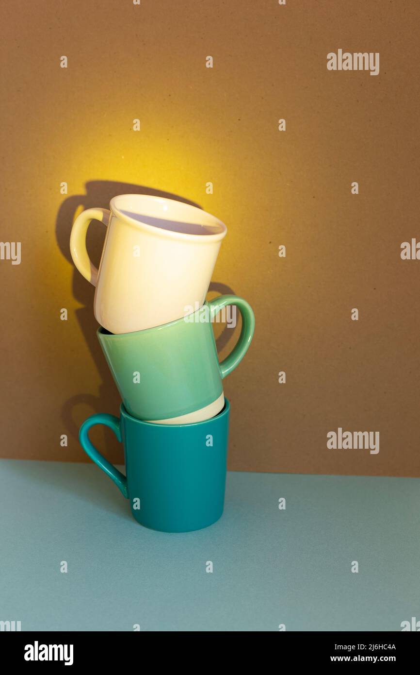 Three cups on blue table. brown wall background Stock Photo