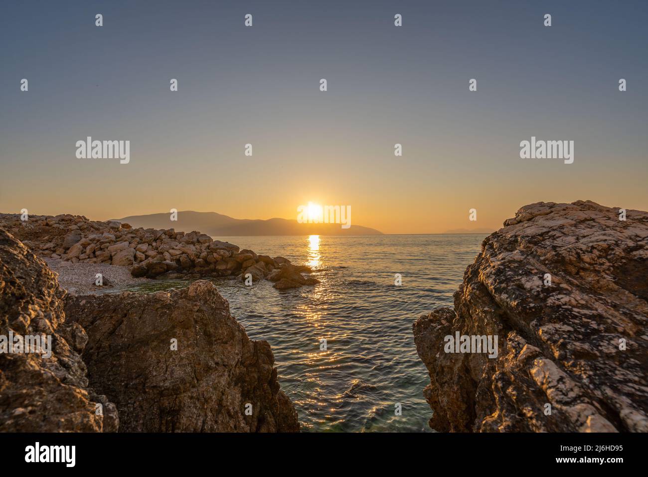 Sunset at rocky stone beach in Albania. Adriatic sea, peninsula